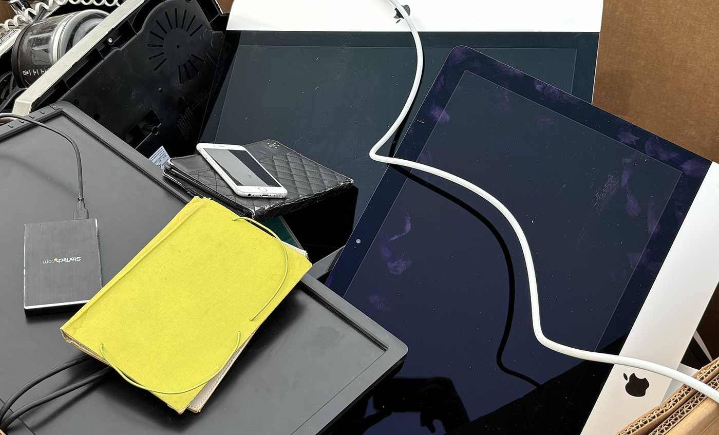 Computers, cell phones, and tablets wait to be recycled